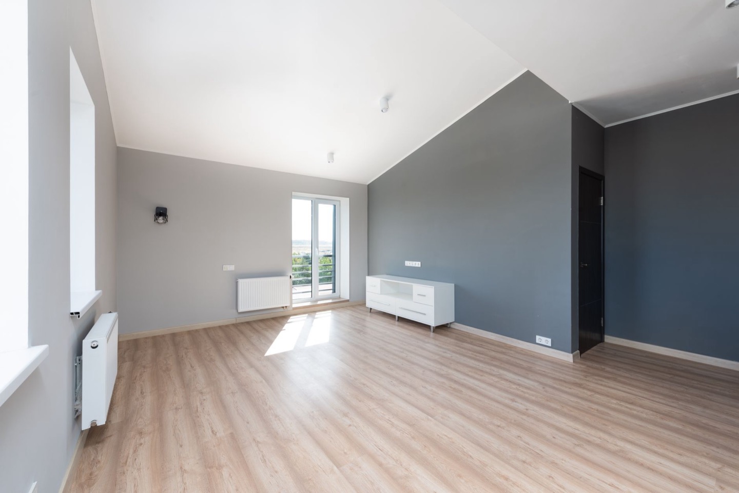 Rental living room before and after repainting in a warmer gray — before