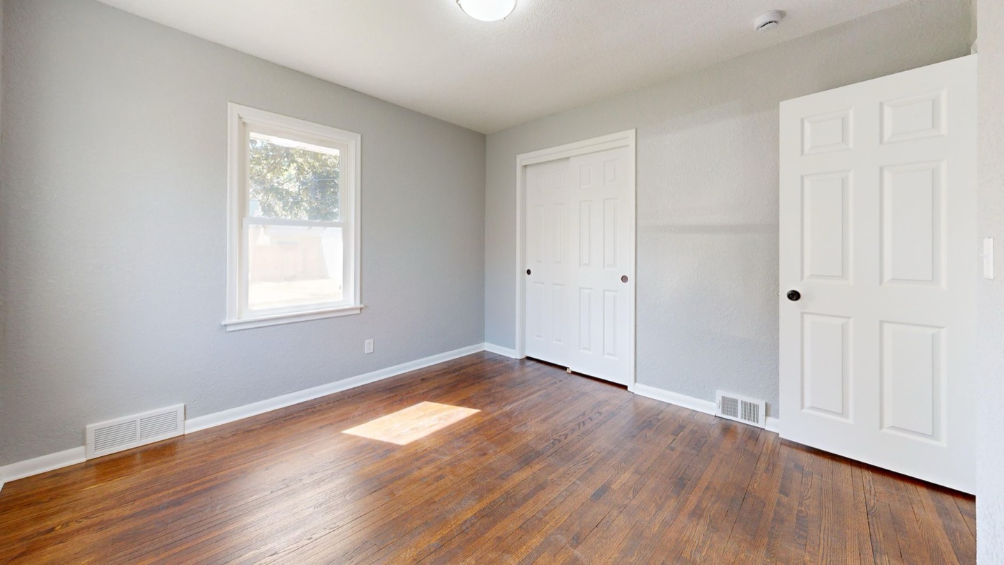 Rental room before and after repainting with an even low-sheen finish — after, restyled by Restage