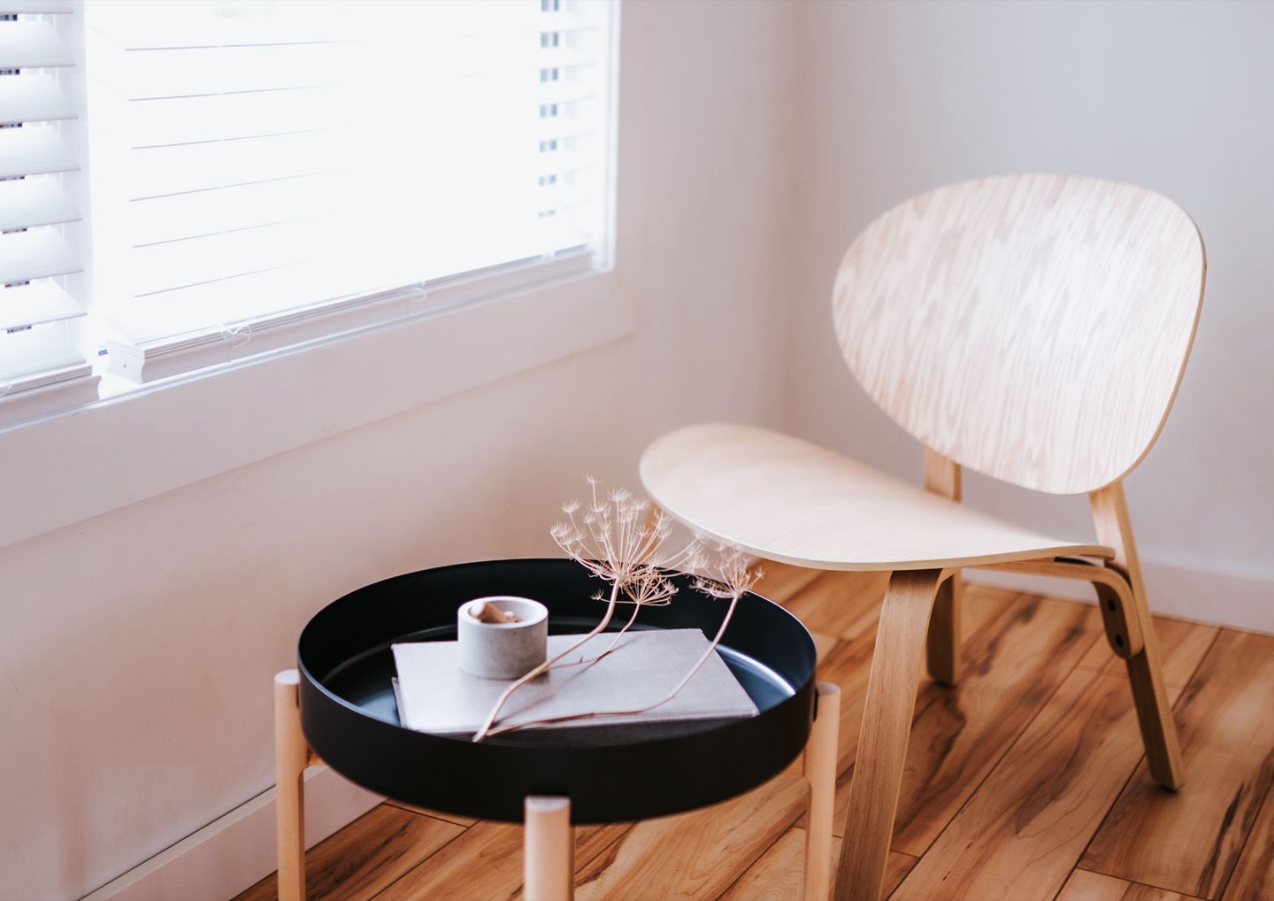Airbnb room before and after a minimal natural-wood restyle — after, restyled by Restage