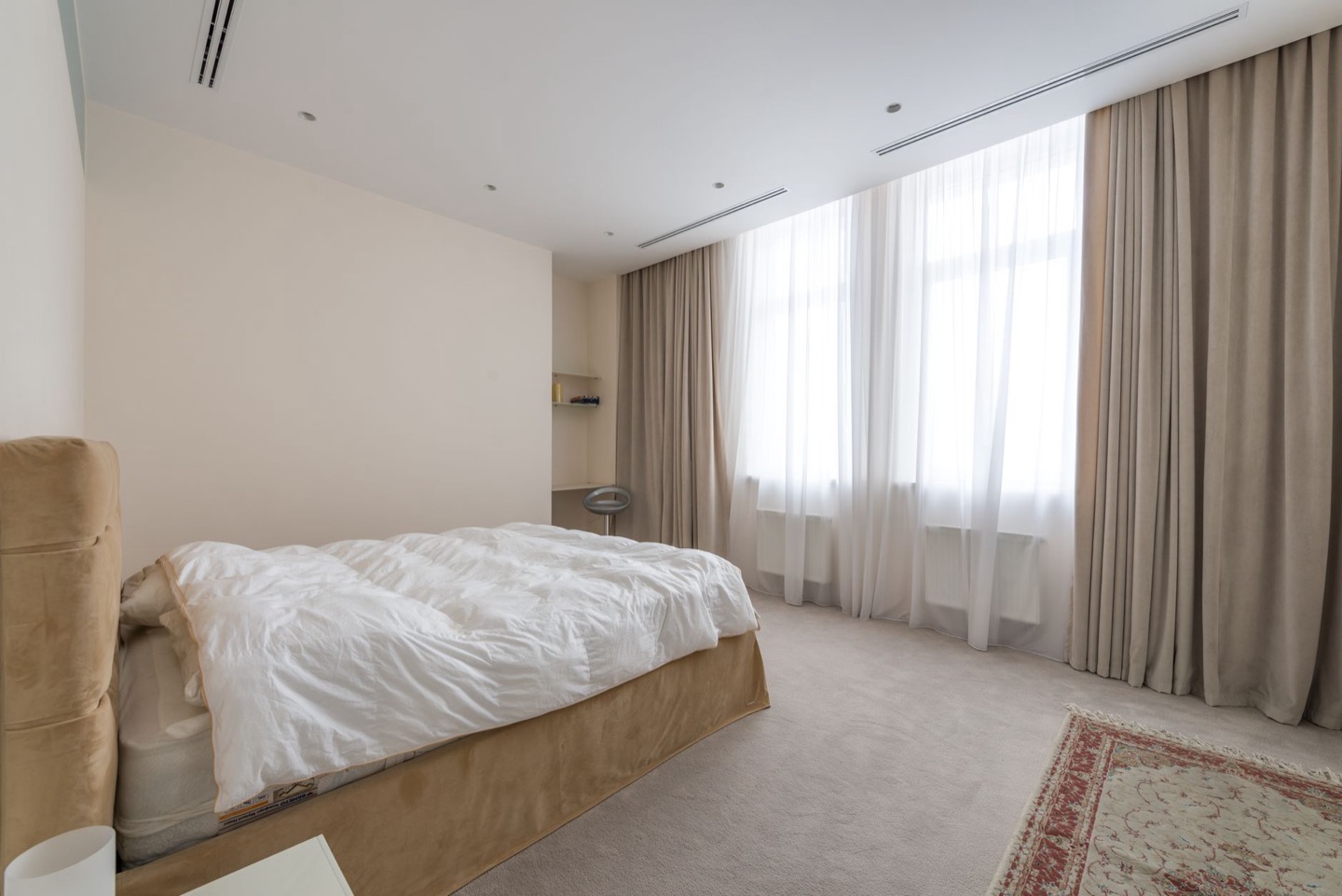 Airbnb room before and after replacing worn flooring — before