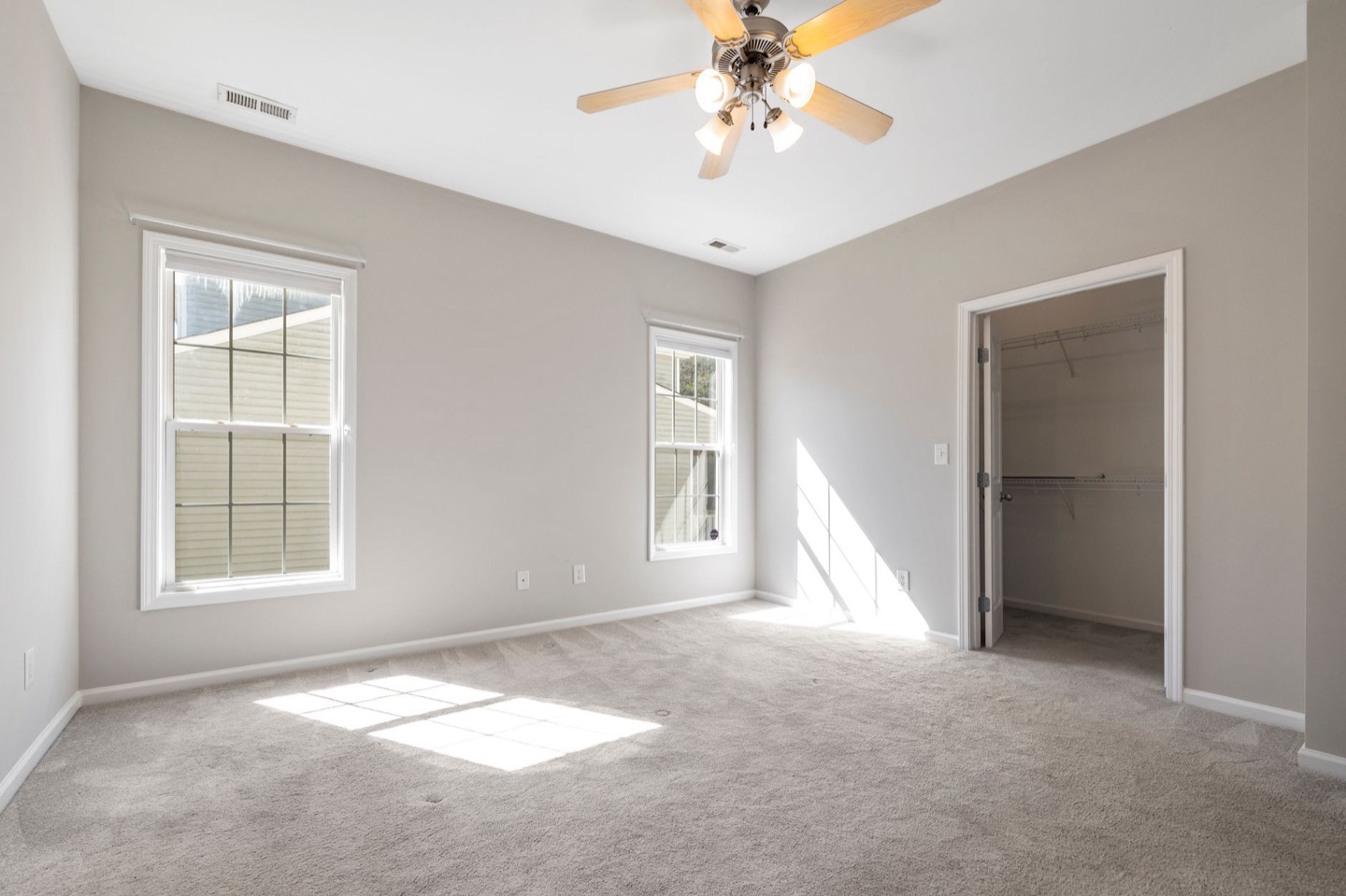 Rental room before and after repainting in a clean warm white — before