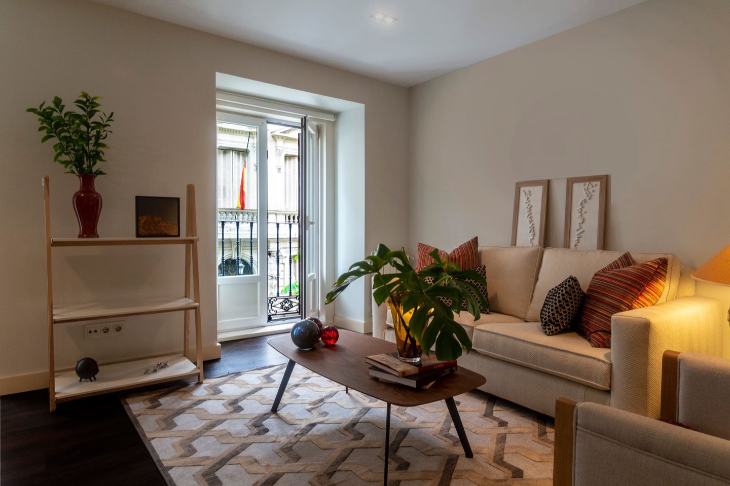 Airbnb living room before and after replacing the sofa with a modern sleeper — after, restyled by Restage