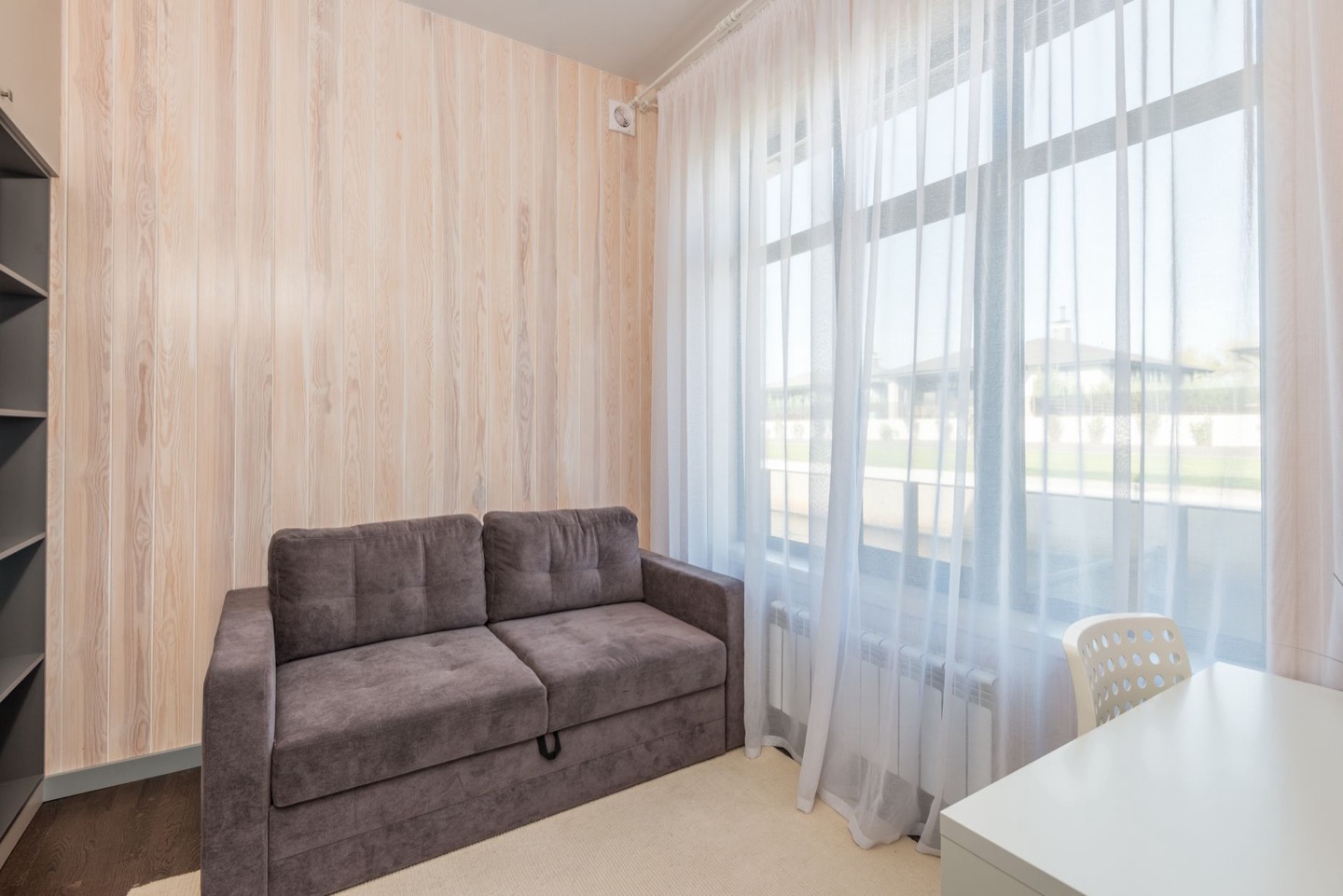 Airbnb living room before and after replacing the sofa with a modern sleeper — before
