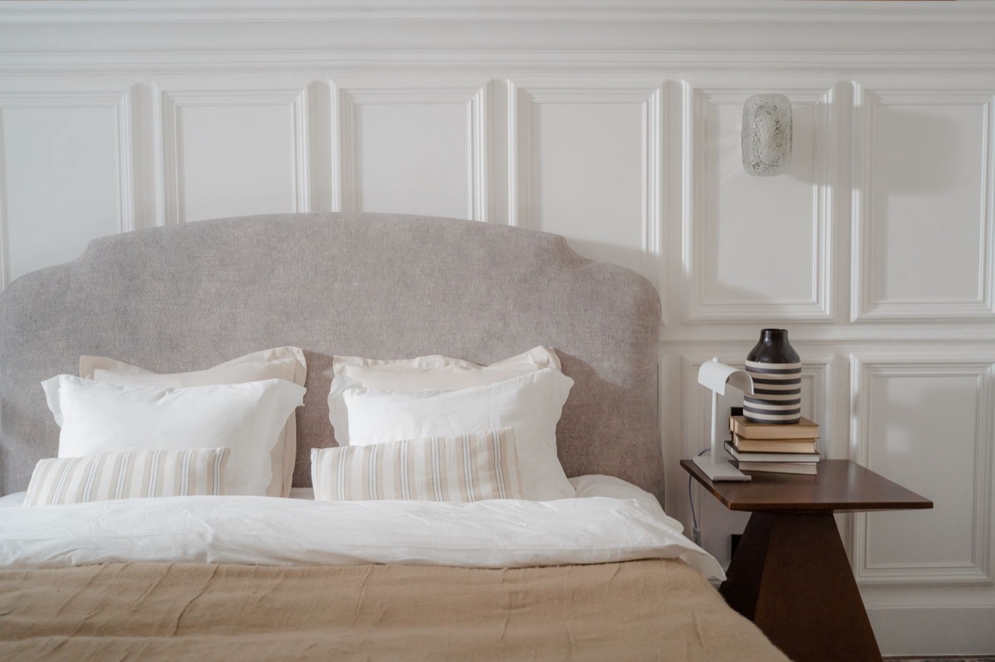 Rental bedroom before and after repainting in a soft warm white — after, restyled by Restage