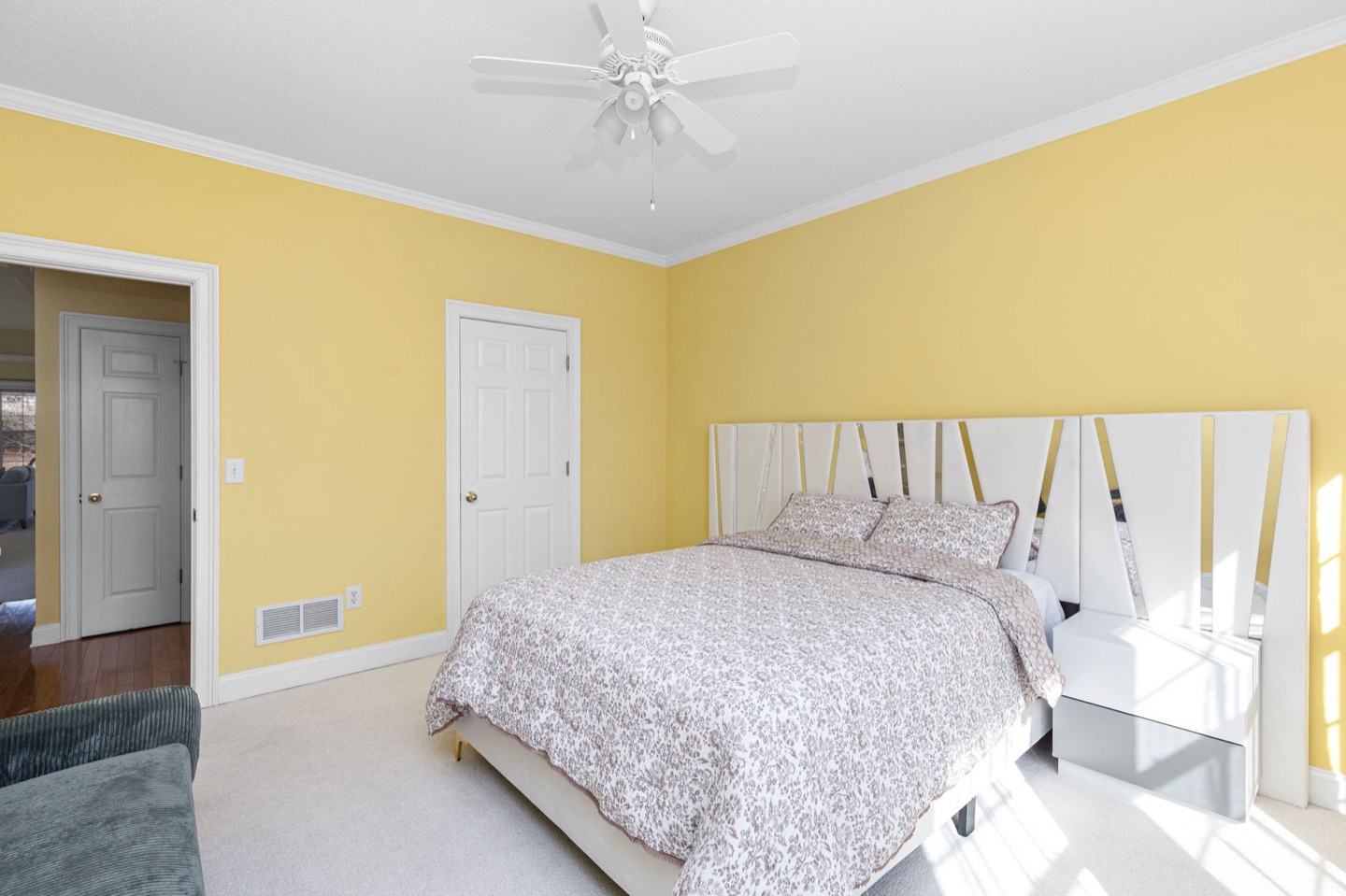 Rental bedroom before and after repainting in a soft warm white — before