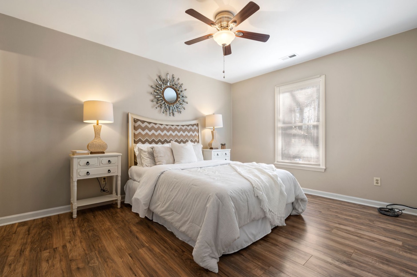 Rental bedroom before and after painting in a soft warm white — after, restyled by Restage