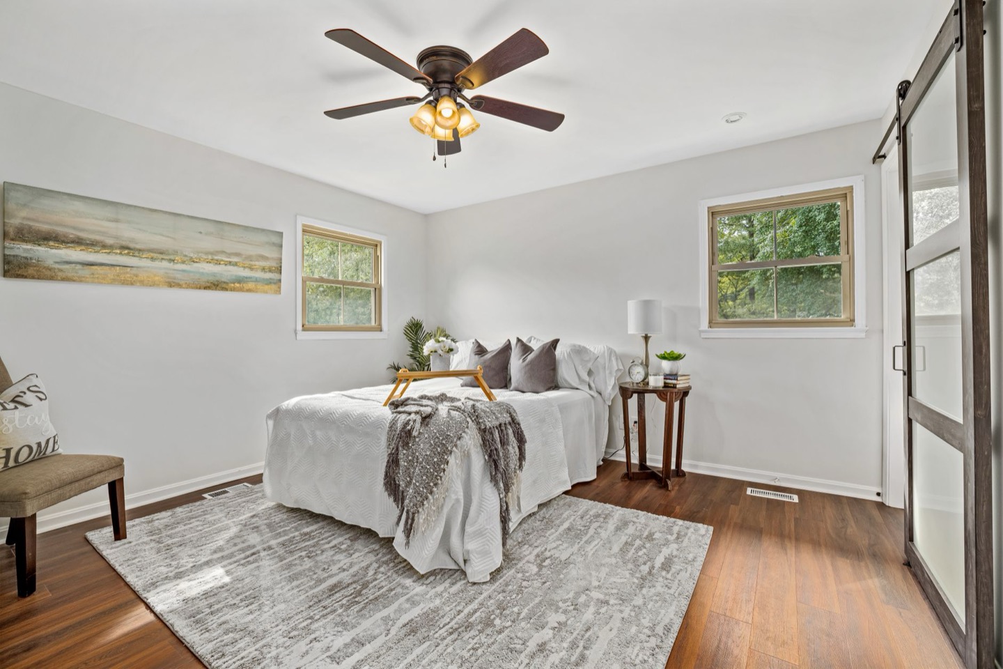 Airbnb bed before and after switching to white bedding with colored layers — after, restyled by Restage